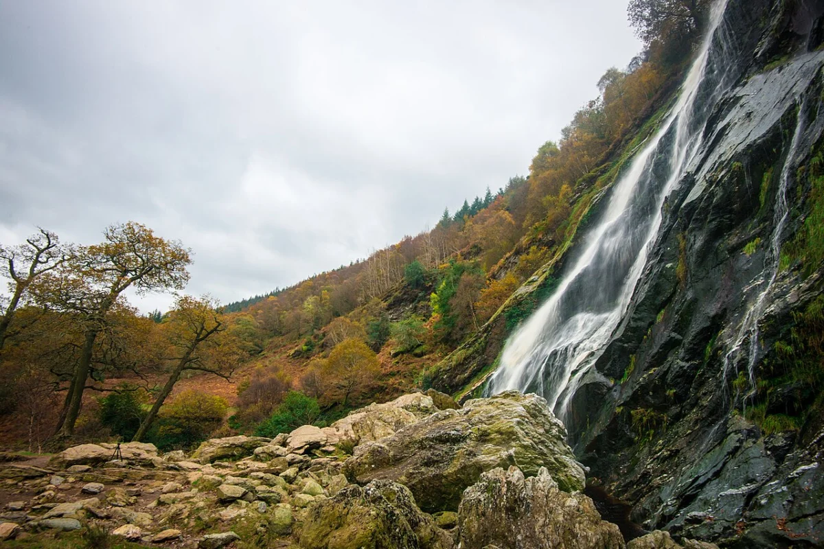 Powerscourt Waterfall pouring down a rock face in autumn, County Wicklow